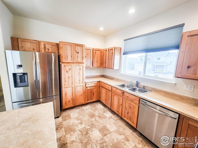 kitchen with a sink, stainless steel appliances, recessed lighting, and light countertops