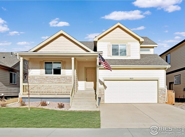 view of front of property featuring stone siding, an attached garage, covered porch, and driveway