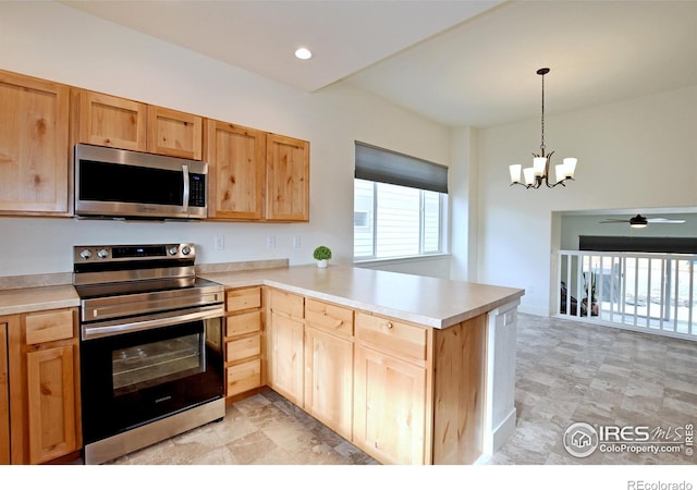 kitchen featuring light brown cabinets, decorative light fixtures, appliances with stainless steel finishes, a peninsula, and light countertops