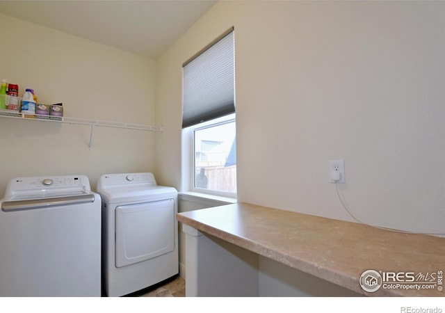 clothes washing area featuring washer and clothes dryer and laundry area