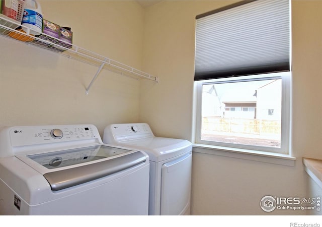 laundry room with separate washer and dryer and laundry area