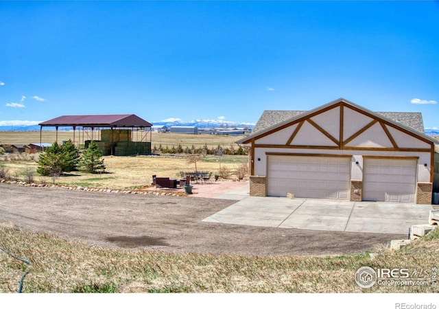 view of front facade with a mountain view and a garage