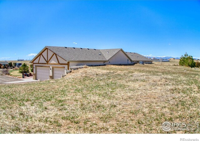 view of front of home with a garage and a front yard