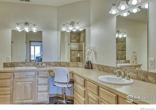 bathroom featuring vanity and a shower