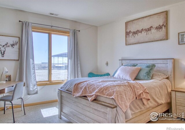 bedroom featuring light carpet