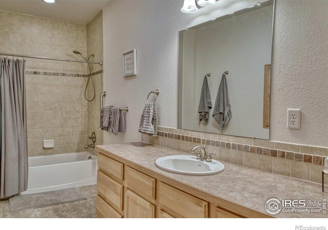 bathroom with vanity, shower / tub combo, and backsplash