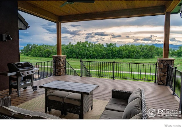 wooden terrace with a lawn, area for grilling, an outdoor living space, and ceiling fan