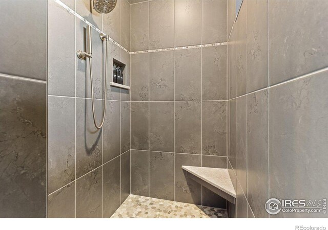 bathroom with a tile shower