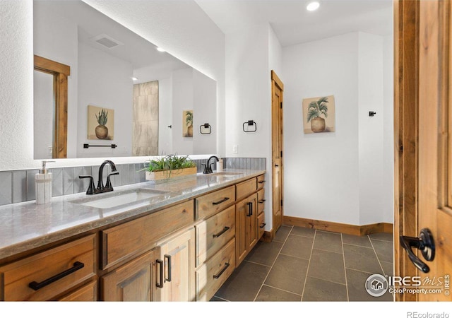 bathroom with tile patterned floors and vanity