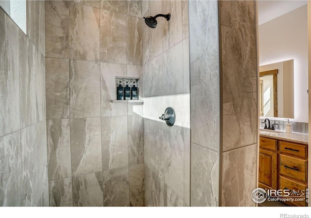 bathroom with vanity and tiled shower