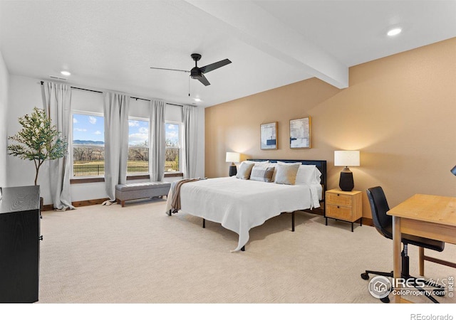 carpeted bedroom featuring beamed ceiling and ceiling fan