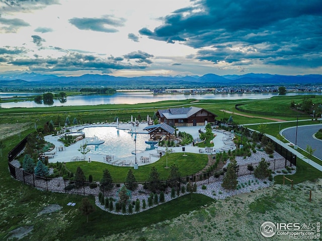 drone / aerial view with a water and mountain view