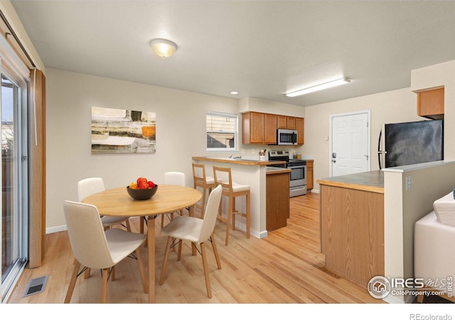 dining area with light hardwood / wood-style floors