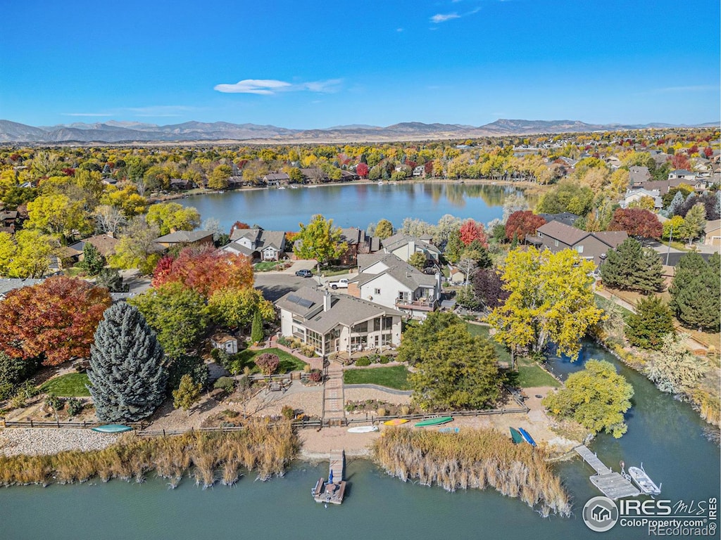 birds eye view of property featuring a water and mountain view