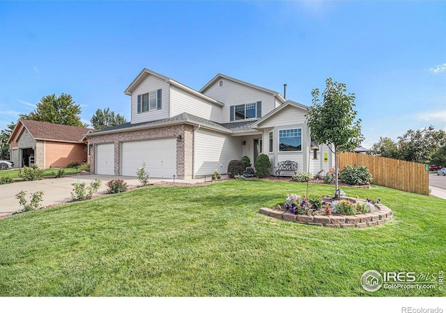 view of property with a garage and a front lawn