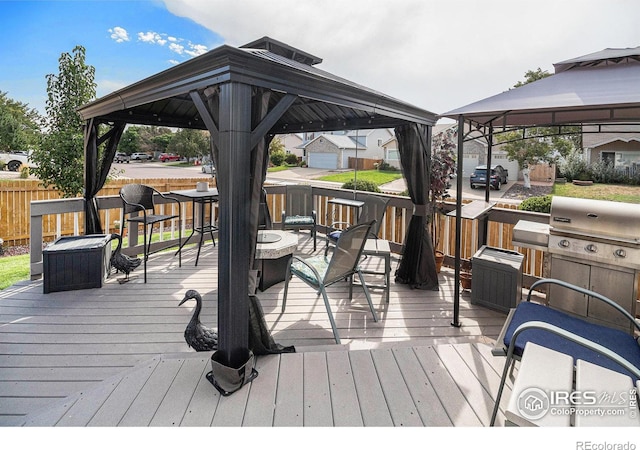 wooden terrace featuring a gazebo