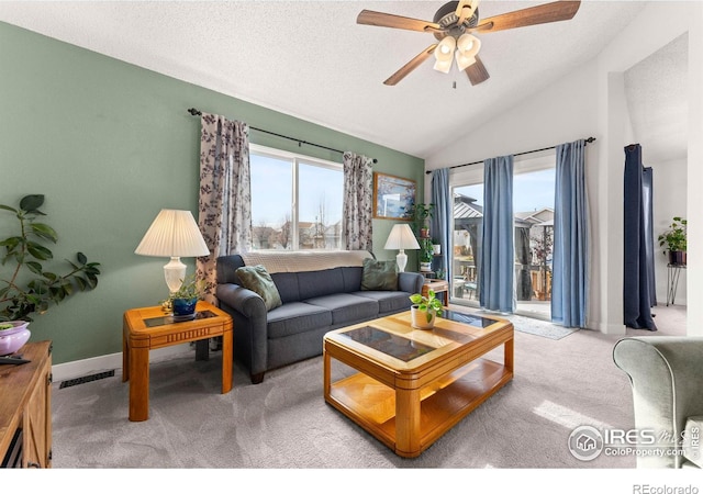 carpeted living room with a textured ceiling, ceiling fan, and lofted ceiling