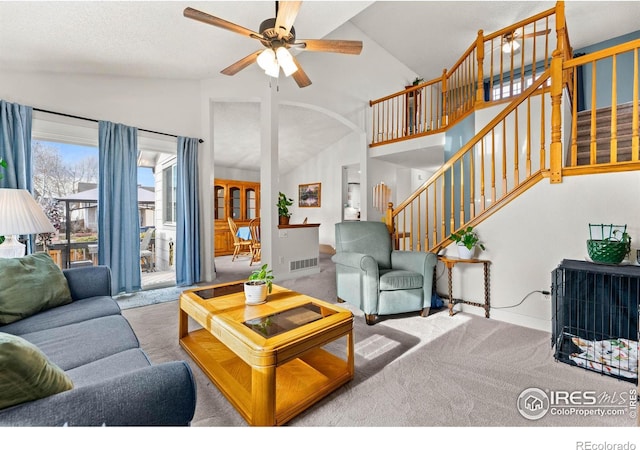 living room featuring ceiling fan, light carpet, and high vaulted ceiling