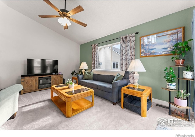 living room featuring carpet flooring, ceiling fan, and lofted ceiling