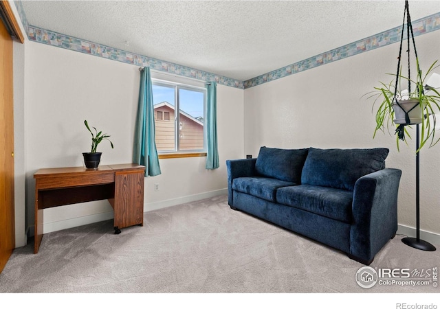 living room featuring light colored carpet and a textured ceiling