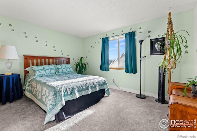 carpeted bedroom featuring a textured ceiling