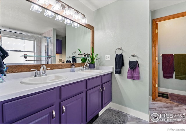 bathroom featuring vanity and a shower with shower door