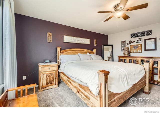 bedroom featuring ceiling fan and carpet