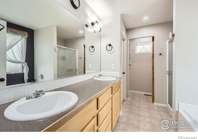 bathroom featuring vanity and an enclosed shower