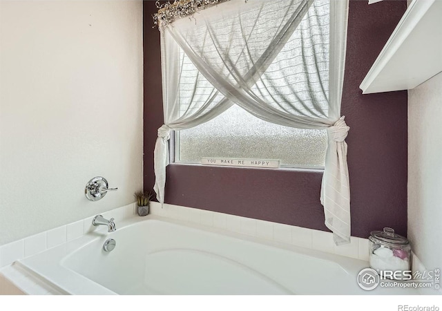 bathroom with a tub to relax in