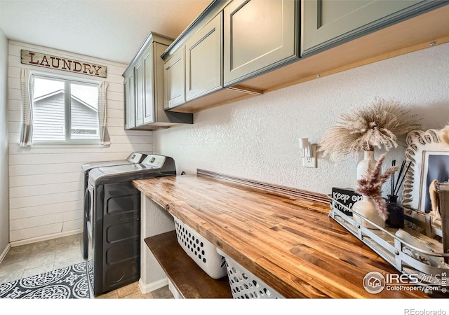 laundry room with washer and dryer and cabinets