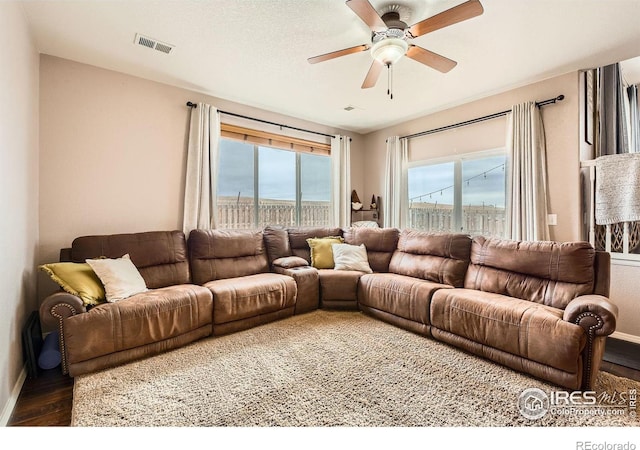 living room with hardwood / wood-style floors and ceiling fan