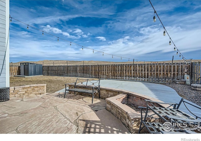 view of patio featuring a storage shed