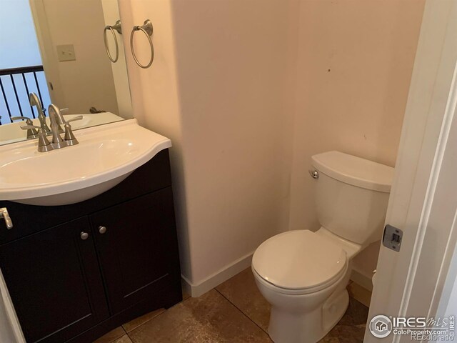 bathroom with vanity, tile patterned flooring, and toilet