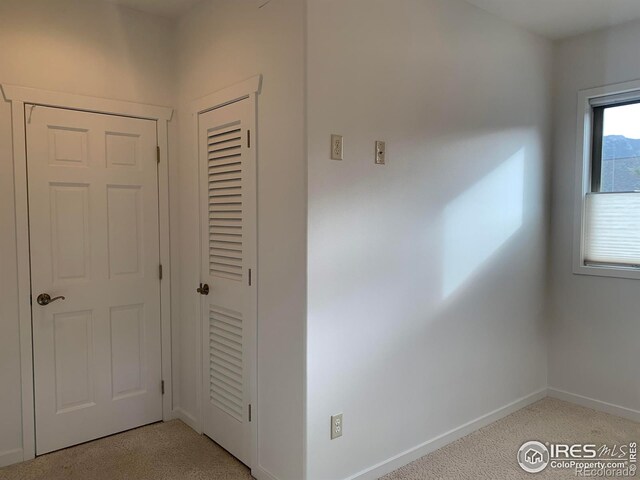 interior space featuring light colored carpet