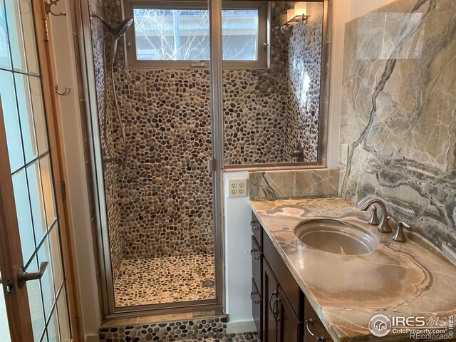 bathroom with vanity and a shower