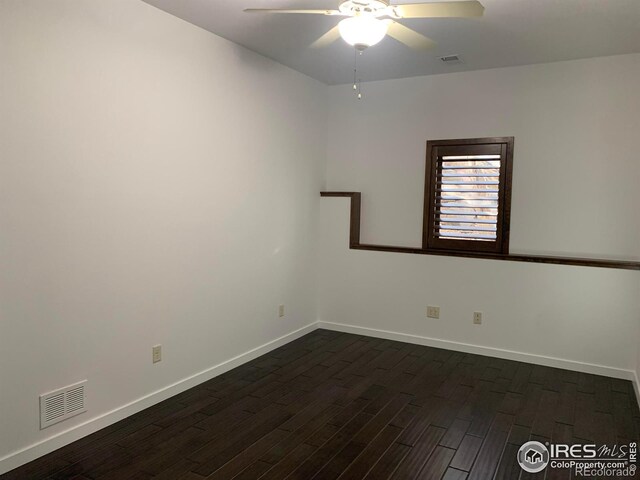 empty room featuring ceiling fan and dark hardwood / wood-style flooring