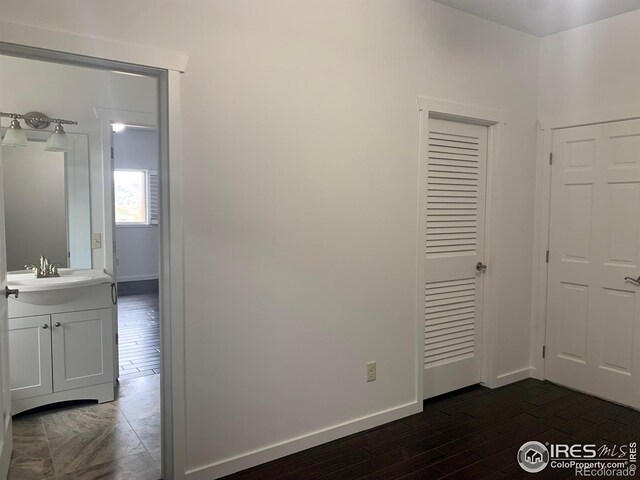 interior space with dark hardwood / wood-style floors and sink