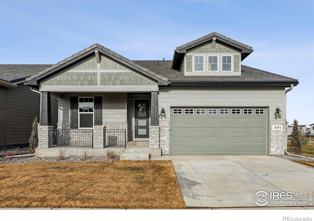 craftsman inspired home with a porch and a garage