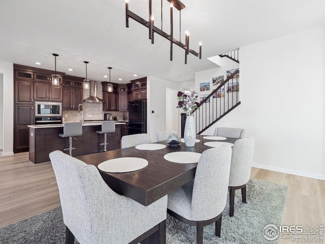 dining space featuring light hardwood / wood-style floors and a chandelier