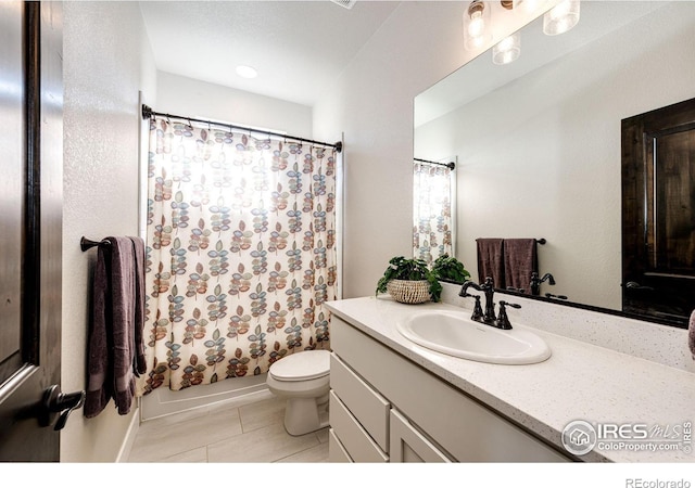 full bathroom with vanity, toilet, tile patterned floors, and shower / bath combo with shower curtain