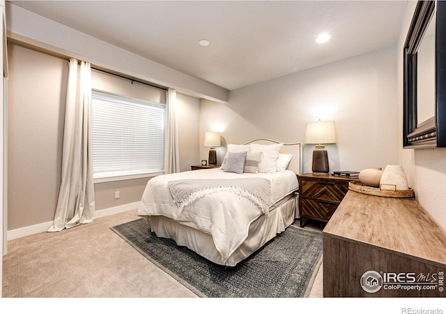 bedroom featuring light colored carpet