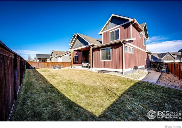 rear view of property with a yard