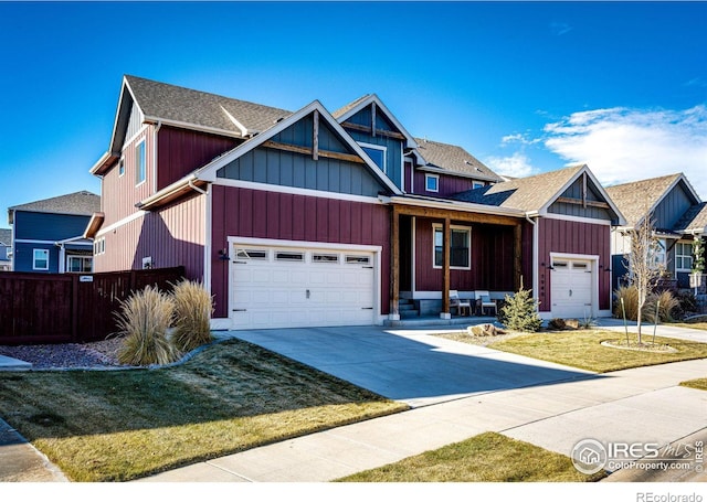 craftsman house featuring a garage and a front yard