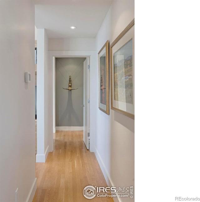 hall featuring recessed lighting, baseboards, and light wood-type flooring