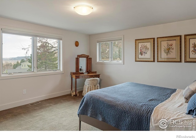 bedroom featuring visible vents, baseboards, and carpet