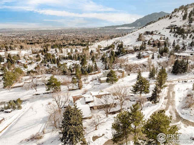 snowy aerial view featuring a mountain view