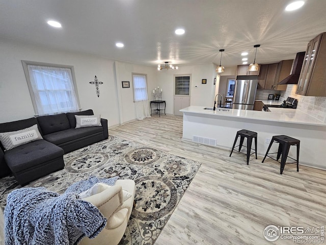 living room featuring light hardwood / wood-style flooring and sink