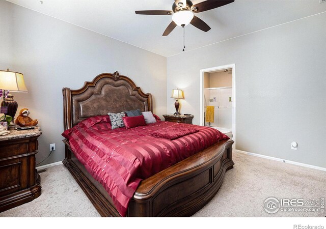 carpeted bedroom featuring baseboards, a ceiling fan, and ensuite bathroom