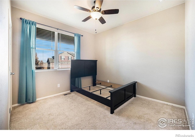 bedroom with baseboards, ceiling fan, and light colored carpet