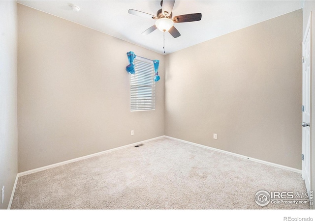 empty room with ceiling fan, carpet floors, and baseboards